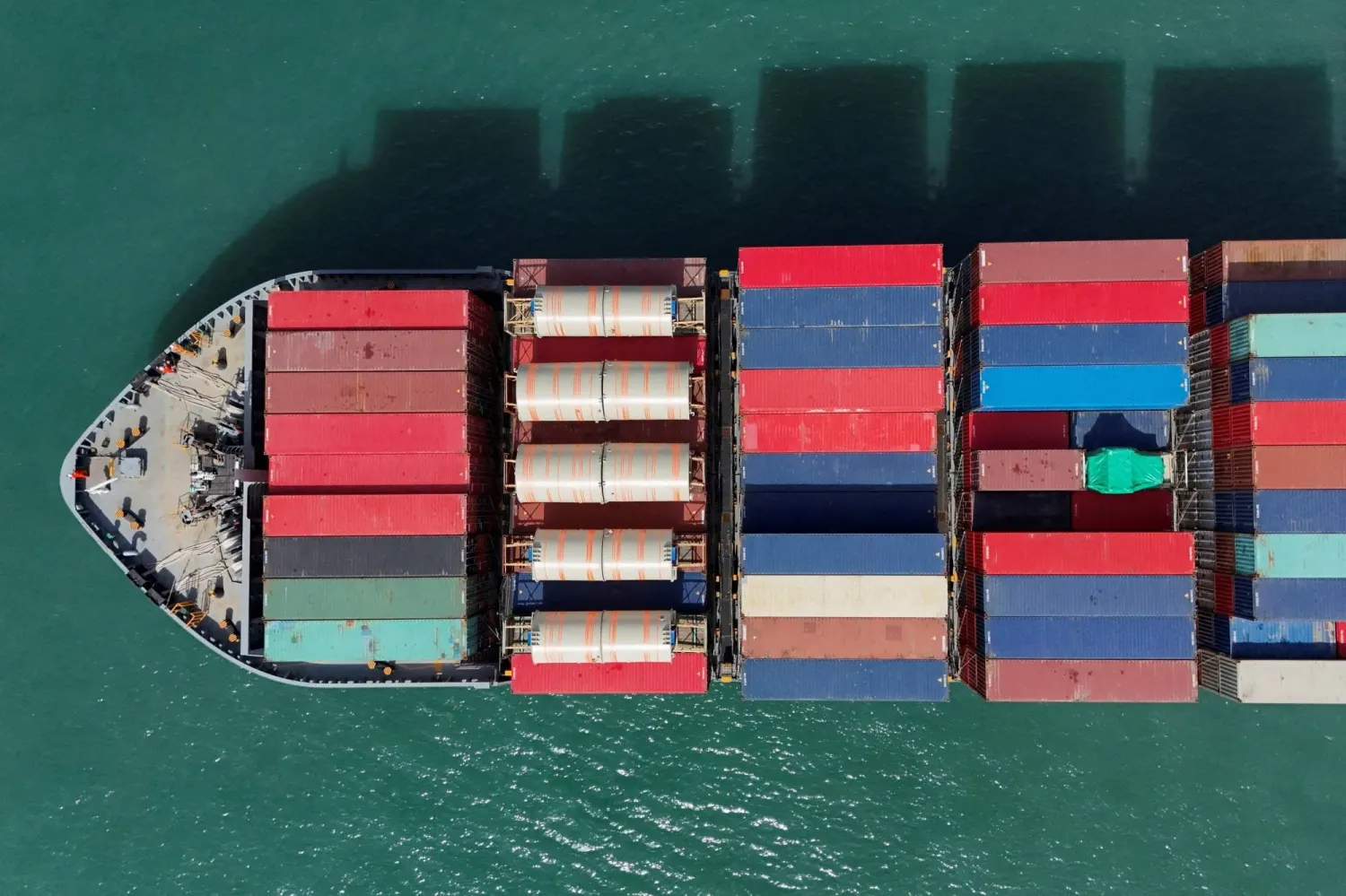 Container ship seen from above, boxes stacked on deck